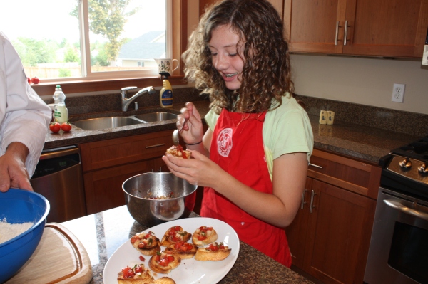 Emily, dressing the bruschetta. It was tomatoes, garlic, olive oil, basil an white nectarines. DELICIOUS!